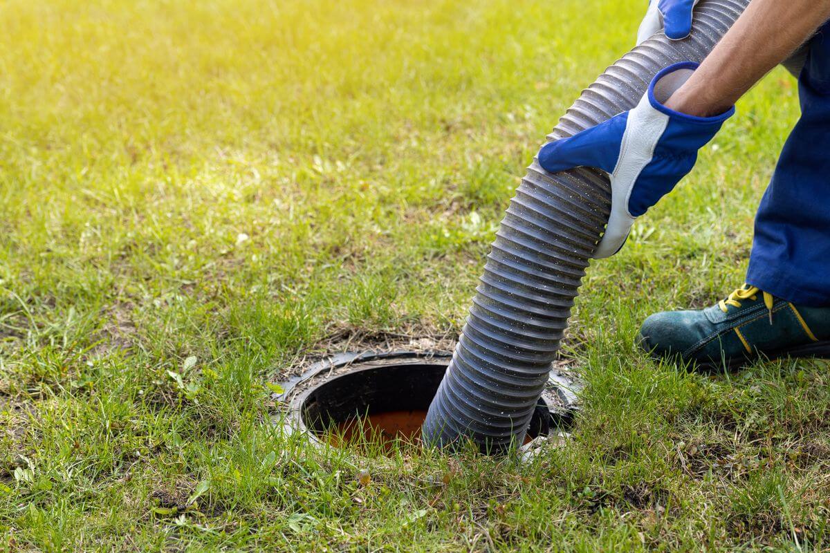 Septic pumping hose inserted into a septic tank